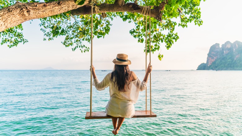 Woman on swing on beach