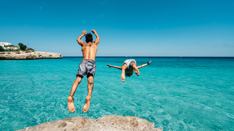 People cliff diving in Mallorca