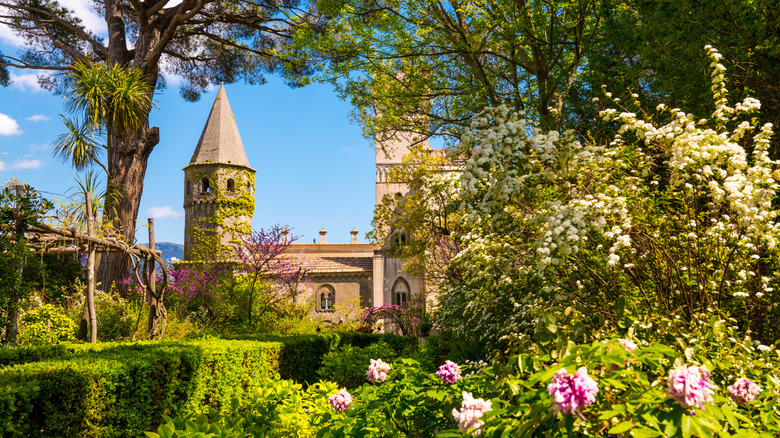 Historic Villa Cimbrone with tower surrounded by gardens, trees, and flowers