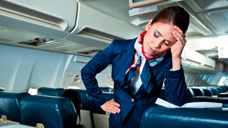 Annoyed flight attendant on plane