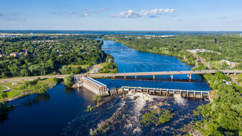 aerial view of Chippewa Falls showcasing a lake, bridges, and greenery