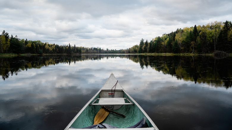 A canoe cuts through glassy water in Voyageurs National Park, Minnesota