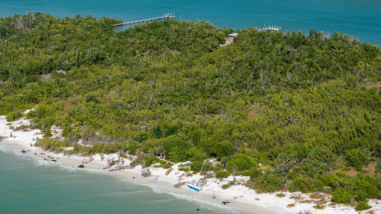 Aerial view of small sailboat aground on an empty beach on Keewaydin Island