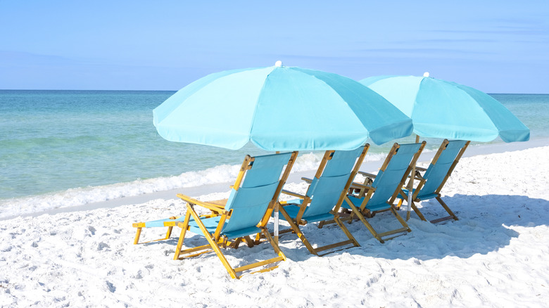 Deckchairs on white sand beach