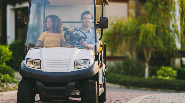 Couple driving a golf cart