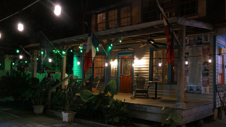 Wooden house with porch at night