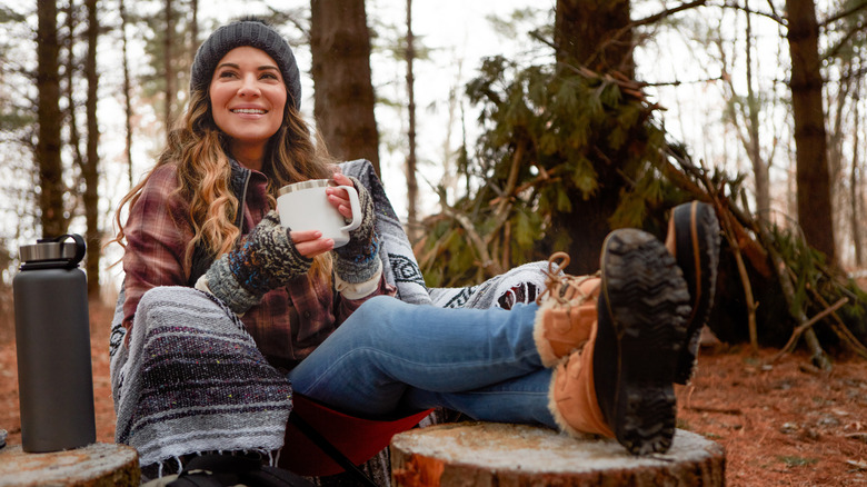 A woman enjoying a hot cup of coffee on a cold day