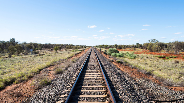 A railroad track runs through the Australian Outback