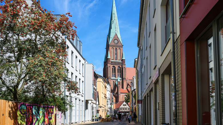 Narrow pedestrian alley leading to Schwerin Cathedral in the background