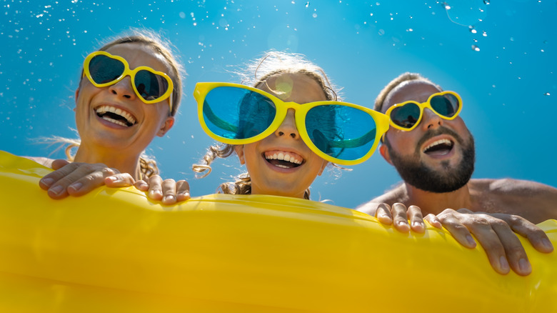 a family of three have fun in a water park