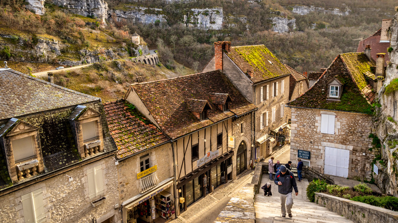 a man climbing the medieval steps in Rocamadour