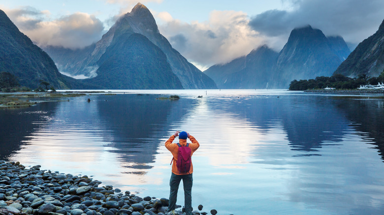 Tourist photographing Milford Sound