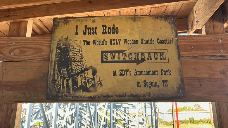 A roller coaster sign reading "I just rode the world's only wooden shuttle coaster! Switchback at ZDT's Amusement Park in Seguin, TX."