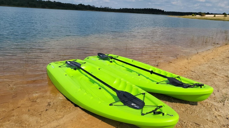 Green kayaks sitting on the sand along Lake Isabel in Bogalusa, Louisiana.