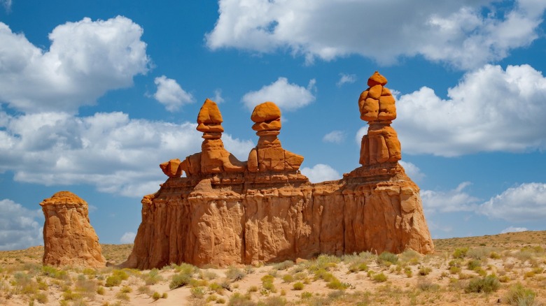 Three Sisters rock formations along a hiking trail at Goblin Valley State Park in Utah