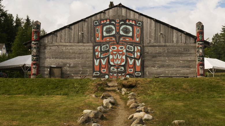 a painted barn and carved Tlingit poles in Haines, Alaska
