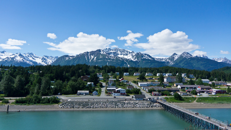 a view of Haines from the water with the snowcapped Chilkat Range in the background in Alaska