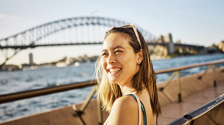 Traveler smiling by Sydney Harbour