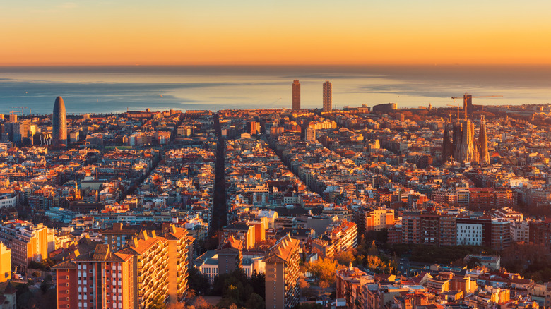 Aerial view over Barcelona and Mediterranean Sea at sunset