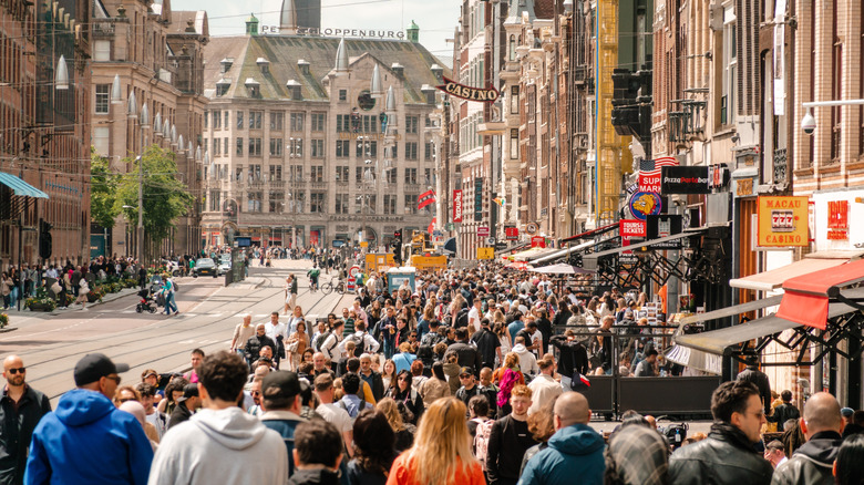 Crowds of tourists on the street in Amsterdam.