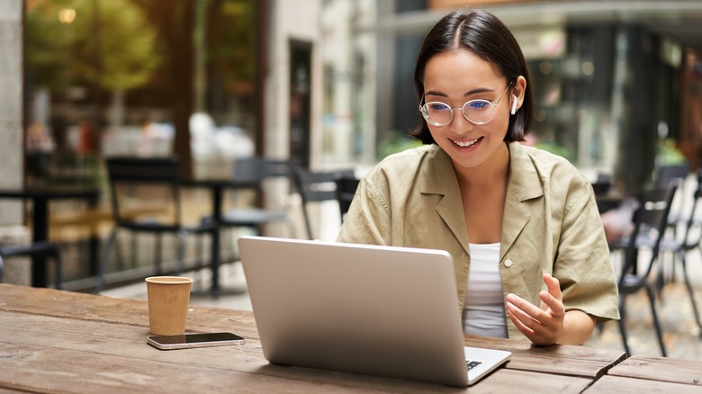 Woman on laptop at cafe