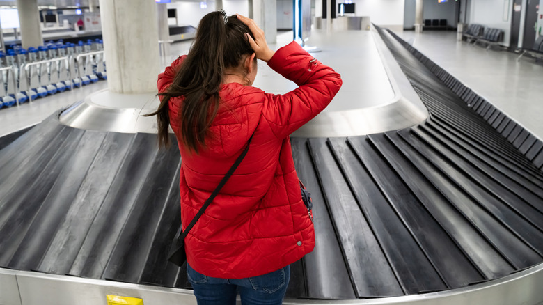Woman in an empty airport baggage claim area