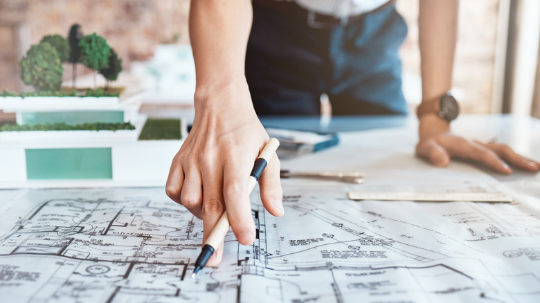 Architect pointing at blueprints