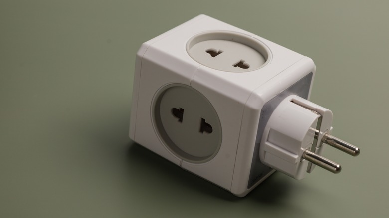 An electrical adapter is displayed on a blank background
