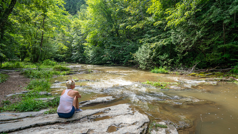 young girl sitting on rocks at Natural Bridge State Park