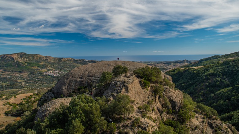 people standing on Pietra Tonda in Aspomonte National Park in Calabria, Italy