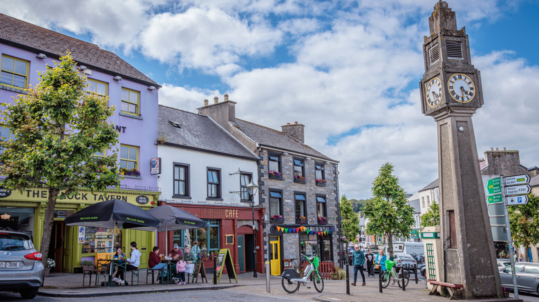 A charming square in Westport, Ireland, with colorful buildings and a clock tower