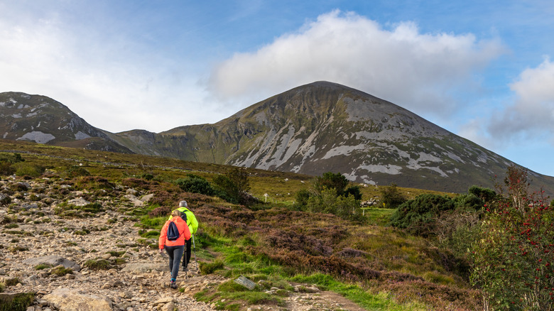 Two hikers making their way toward the Croagh Patrick mountain
