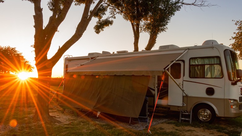 A parked RV with sunset in the background