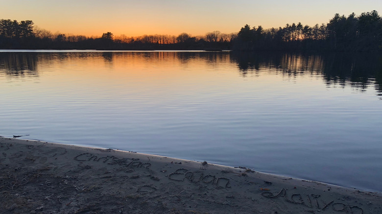 Names written in the sand at Webster Lake Memorial Beach along Webster Lake.