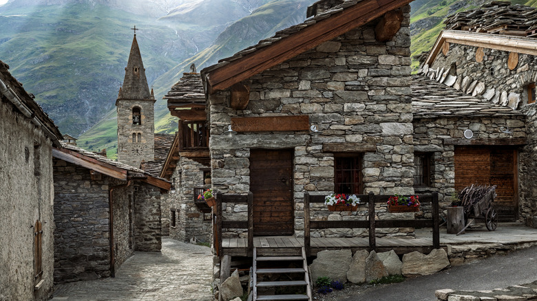 A picturesque view of a traditional alpine stone village with old church