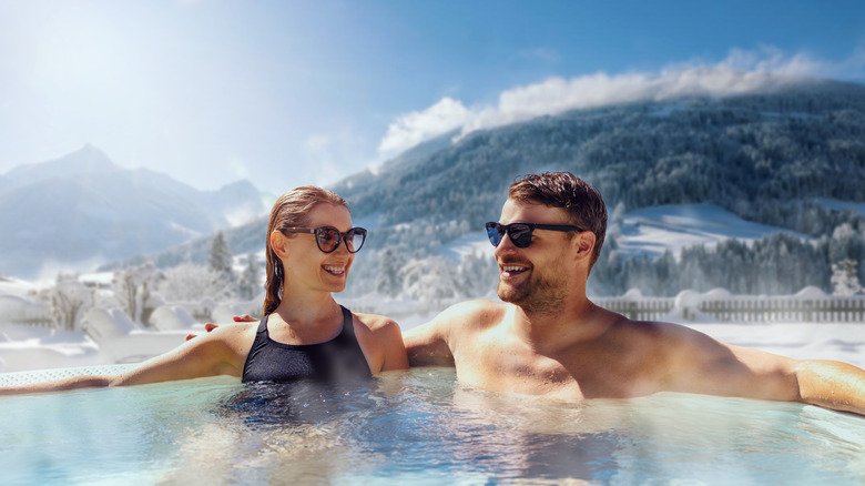 A couple sitting in mountain hot springs