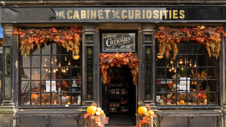 storefront decorated with leaves and pumpkins for fall