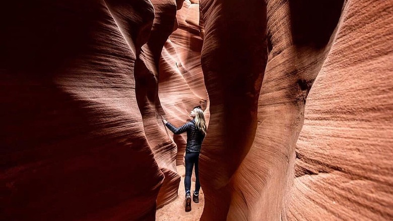 woman exploring slot canyon