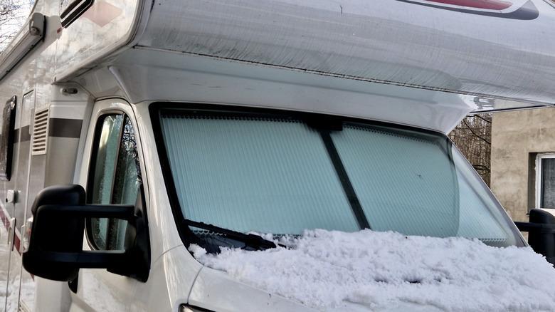 front window shades in RV with snow on hood