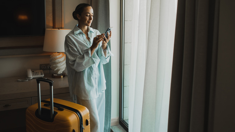 Traveler standing in hotel room
