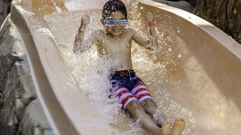 Boy going down a waterslide