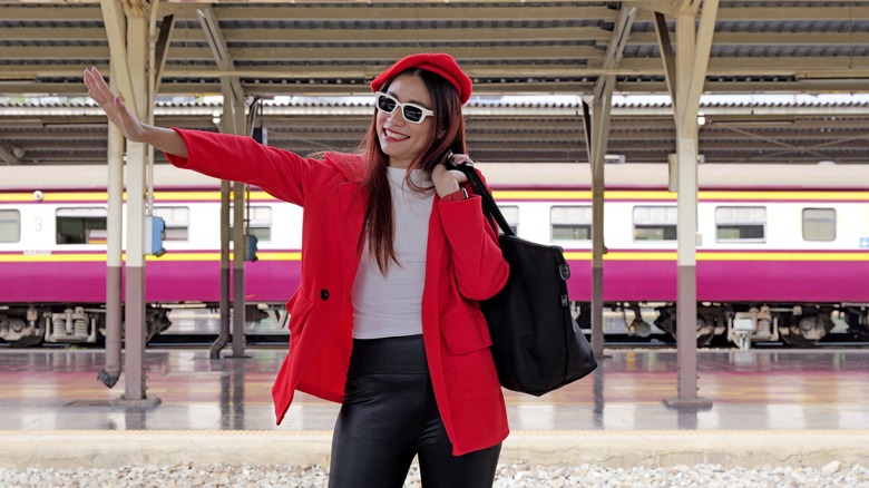 A happy woman in red coat with matching red beret