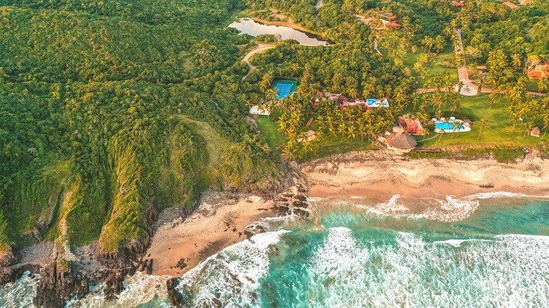 Aerial shot of Las Alamandas hotel with the beach in the foreground