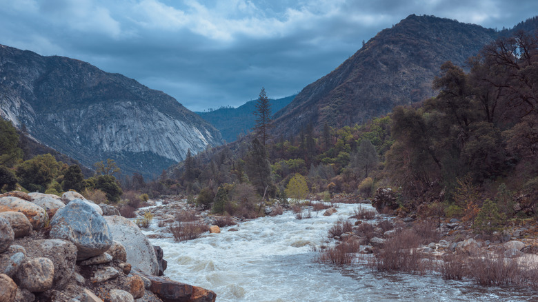 beautiful view on mountains with trees, snow and river at Yosemite National Park