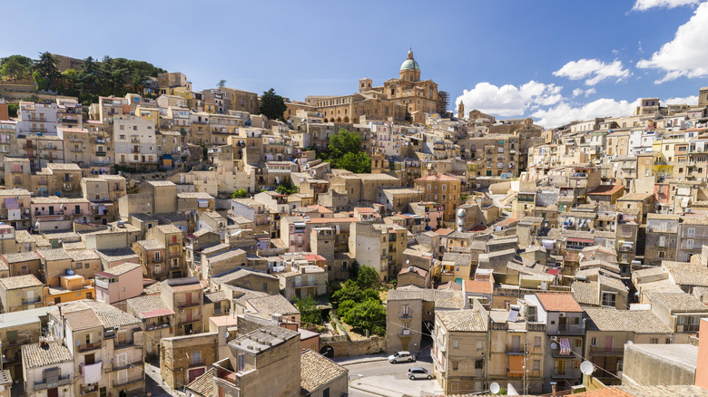 The center of Piazza Armerina overlooked by a domed cathedral situated on a hillside