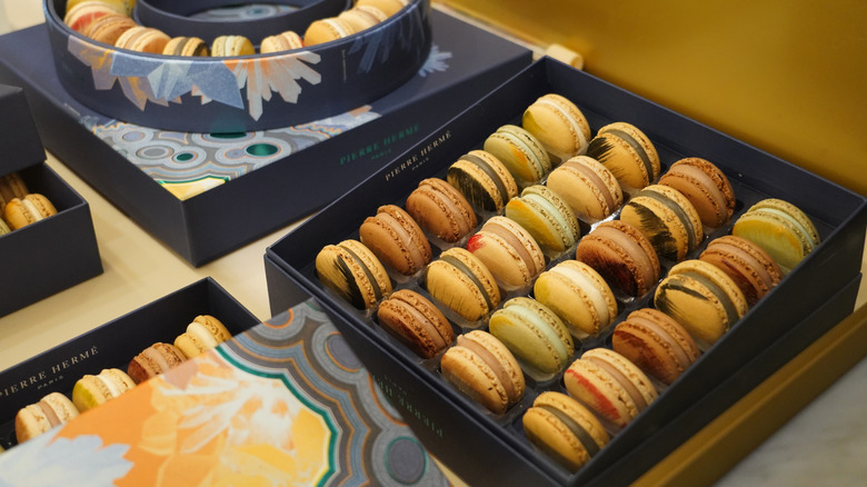 Display boxes of Pierre Hermé macarons.