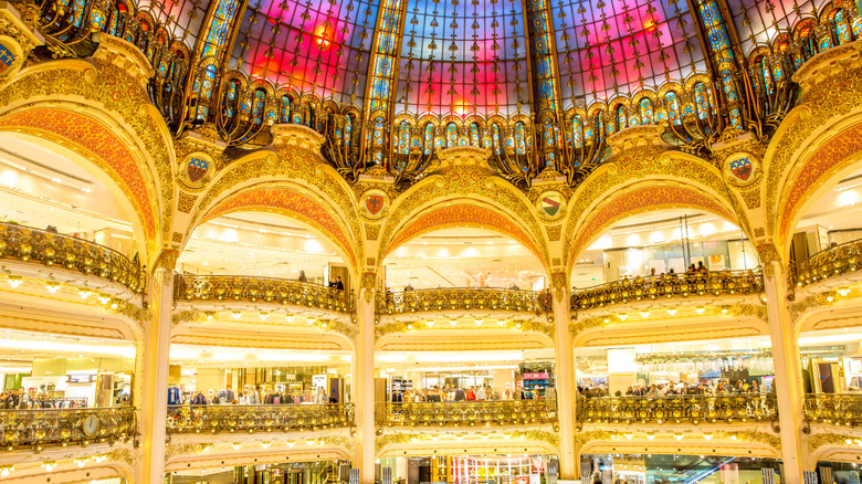 Gold shopping stalls and a stained glass dome inside Galeries Lafayette.