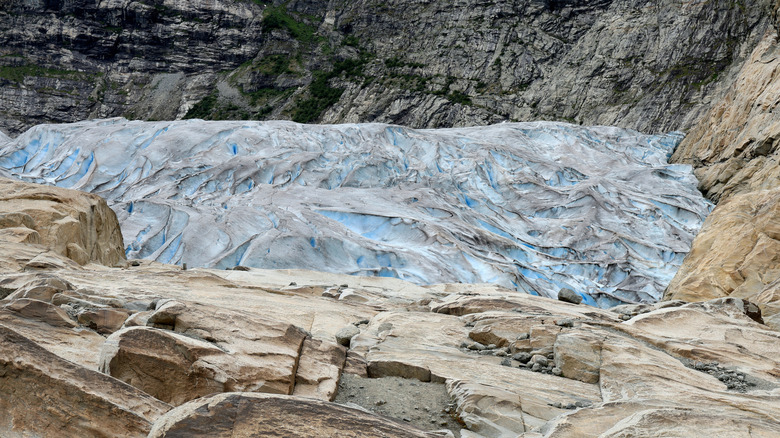 The blue and gray Jostedal glacier, surrounded by rocks