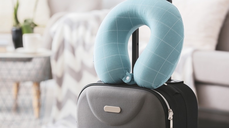Travel neck pillow sitting on suitcase