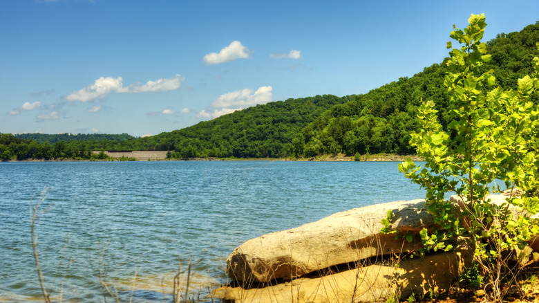 Blue lake viewed from rocky shore